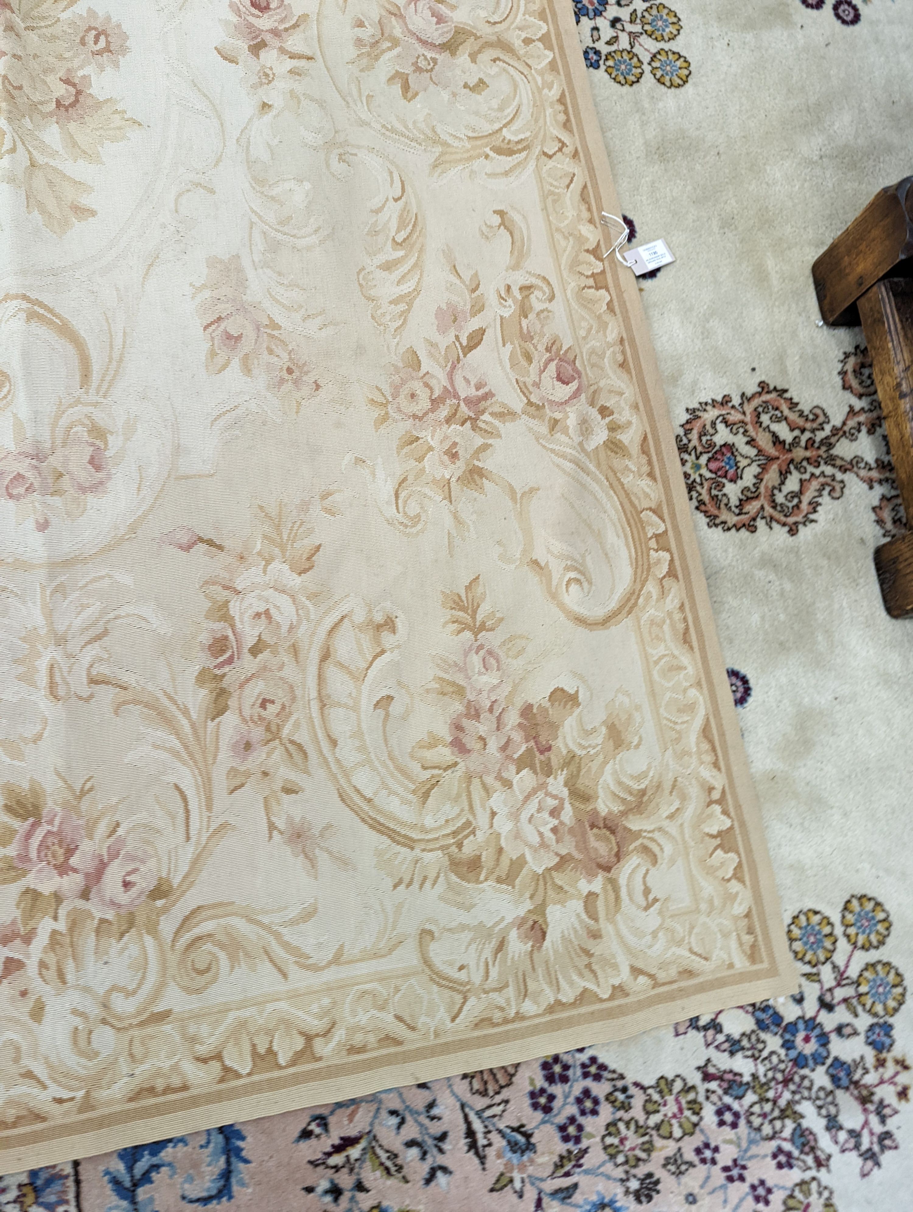 An Aubusson gold ground rug with rose pattern, 244 x 153cm